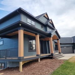 A modern home with dark seamless gutters blending seamlessly with the dark exterior, enhancing both function and curb appeal