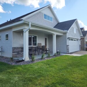 Light gray house showing new gutters in white
