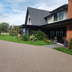 A stunning luxury home featuring newly installed seamless gutters by a trusted local gutter company, enhancing both functionality and curb appeal