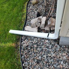 Close-up view of gutter downspout hinges, designed for better water drainage and easy maintenance