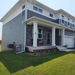 A home in Buffalo, MN, featuring newly installed seamless gutters and downspouts, expertly installed to enhance drainage and protect the property