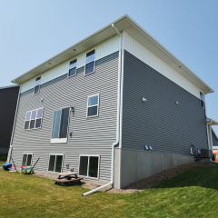 A beautifully landscaped home in Otsego, MN, featuring professionally installed rain gutters for optimal water management and property protection