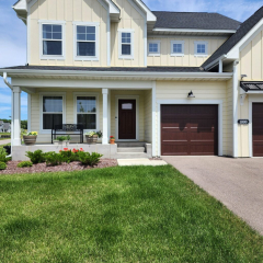A charming yellow home in Rogers, MN, featuring newly installed white seamless gutters for a clean and polished look