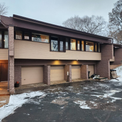 Front view of town homes in Plymouth showcasing Royal Brown gutters installed by Call The Gutter Guys