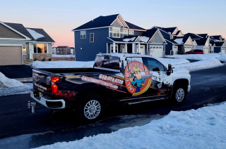 Chevy work truck equipped for seamless gutter installation, parked at a job site