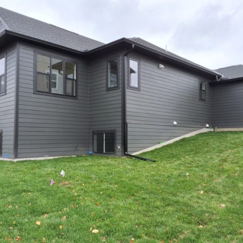 Black seamless gutters installed on a new build home in Delano MN by Call The Gutter Guys