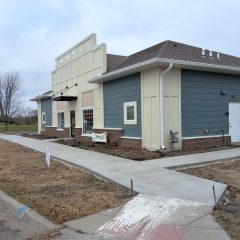 Chiropractic office in Delano with white seamless gutters and downspouts against blue color siding