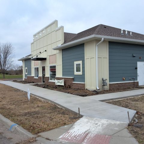 Chiropractic office in Delano with white seamless gutters and downspouts against blue color siding