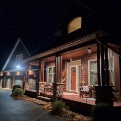 Brown gutters on front porch overhang at night in Plymouth MN