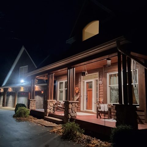 Brown gutters on front porch overhang at night in Plymouth MN