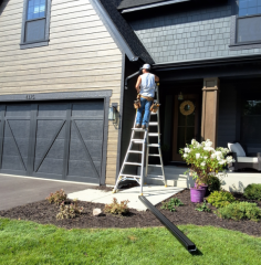 Installing black 6 inch gutters on angled fascia in Victoria MN with Call The Gutter Guys
