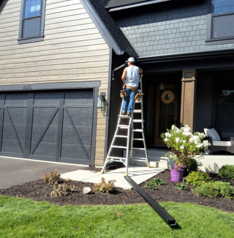 Installing black 6 inch gutters on angled fascia in Victoria MN with Call The Gutter Guys