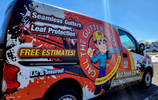 A Call The Gutter Guys service van with bold branding, advertising seamless gutters, leaf protection, and free estimates. The van features a colorful design with the company’s logo, contact number, and website